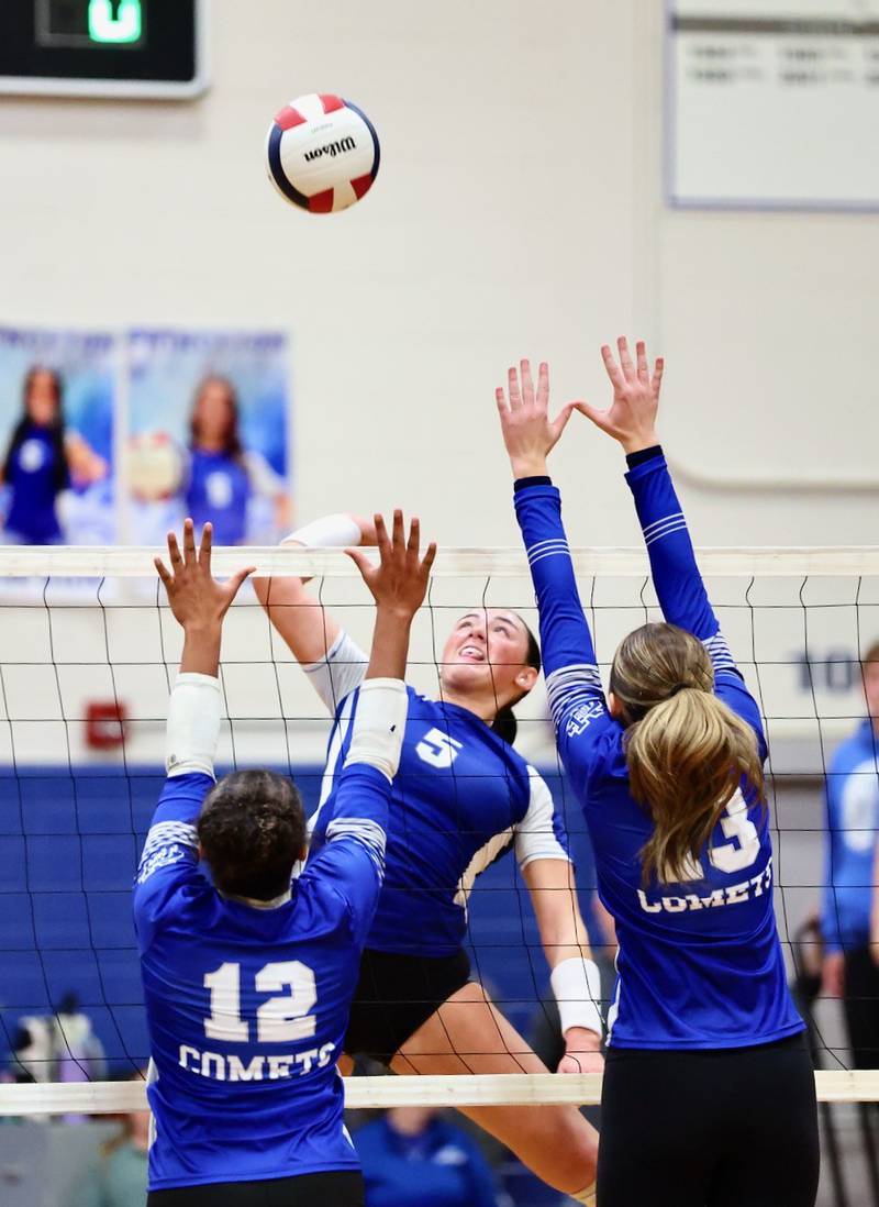 Princeton's Keely Lawson winds up for a hit against Sterling Newman's Giselle Martin (12) and Kennedi Shippert (13) in Thursday's regional finals at Prouty Gym.