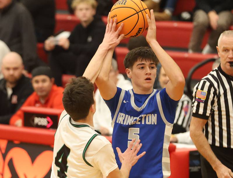 Princeton's Jack Oester looks for an open man as Eureka's Connell Roth slaps the ball during the Colmone Classic on Thursday, Dec. 11, 2025 at Hall High School.