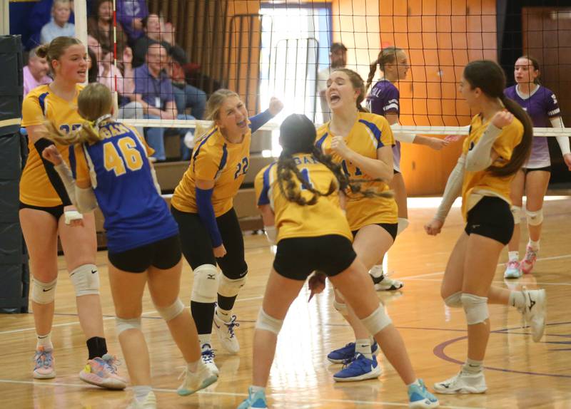 Members of the Logan eighth-grade girls volleball team react after scoring a point against Rockford-Marshall during the IESA Class 3A eighth-grade Regional final game on Thursday, March 13, 2025 at Logan Junior High School in Princeton.