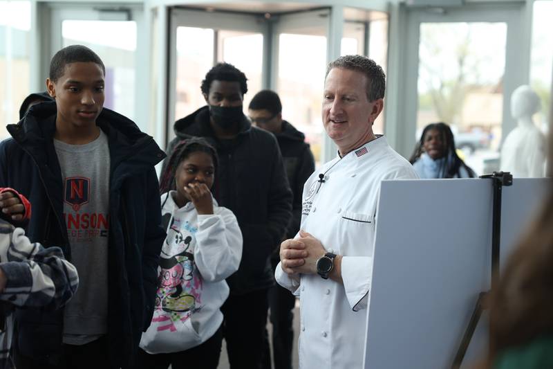 Chef Michael McGreal, Department Chair at Joliet Junior College, greets high school students at a nutritional and wellness event hosted by Joliet Junior College on Friday, April 21, 2023 in Joliet.