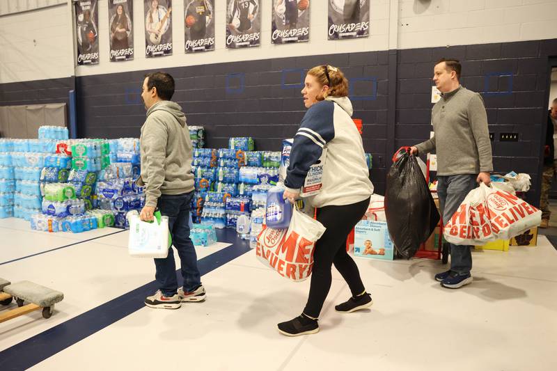 Volunteers arrive with supplies at Grace Christian Academy on Thursday, March 12, 2026, following the EF-3 tornado that tore through Kankakee County on March 10. The school, which is on the outskirts of Aroma Township along Waldron Road, canceled classes in order to become a supply and meal hub for those impacted by the storm.