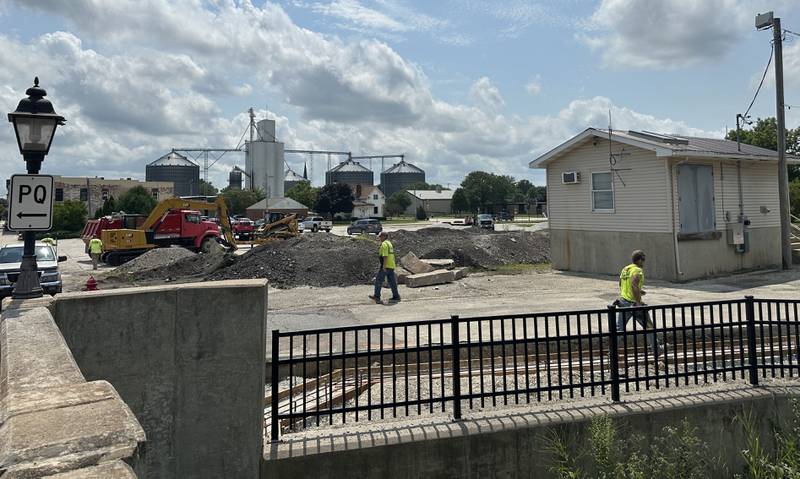 Crews begin construction on the Utica retail plaza on Monday, July 15, 2024 near the intersection of Mill and Grove Streets. Workers poured a sidewalk and have started the preliminary work on the Market on Mill area. The project is scheduled to be completed just before Burgoo.