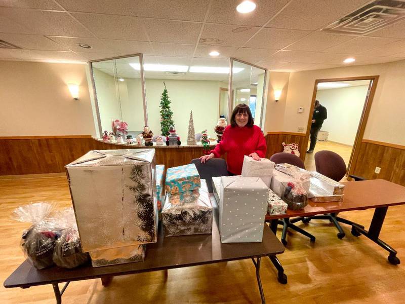 Riverside Community Liaison Nancy Moore poses in 2024 with donations from Santa's Sleigh. This year, gifts were donated to over 50 local families.