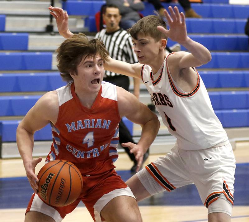 Marian Central's Jackson Jakubowicz drives the baseline against DeKalb's Jackson Kees during a Central High School’s Dr. Martin Luther King, Jr., Boys Basketball Tournament game Friday, Jan. 13, 2023, at Central High School in Burlington.