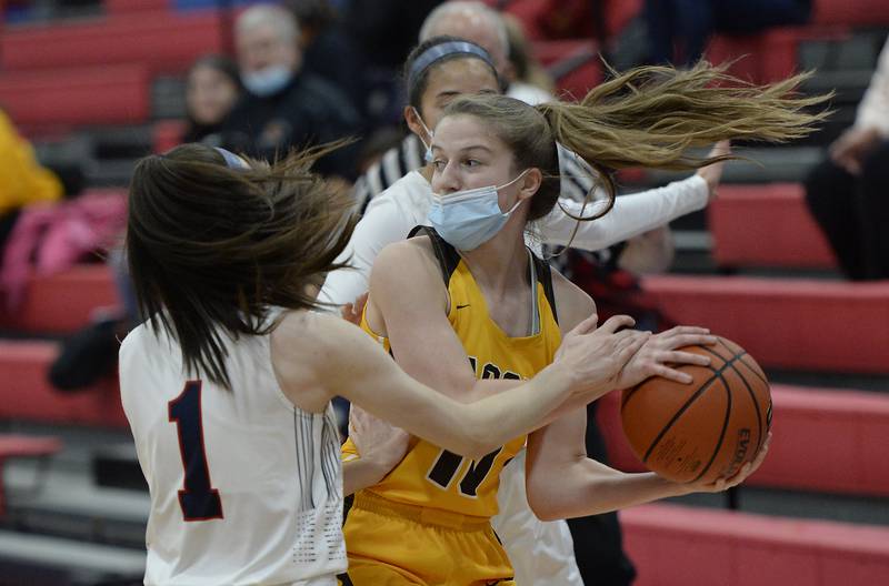 Jacobs' Mackenzie Leahy looks for a teammate to pass off to as St. Viator's defense including Nora Ahram traps her during the first quarter game action of girls basketball at Dundee-Crown on Friday.