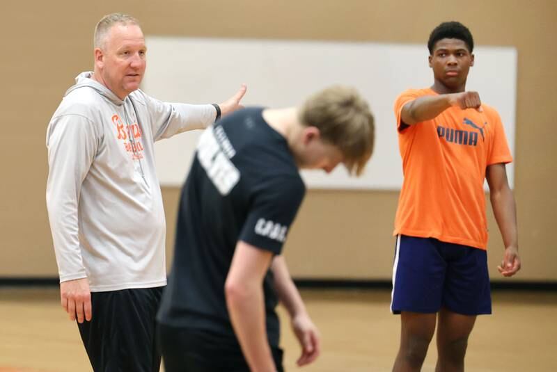 DeKalb boys basketball head coach Mike Reynolds talks to his players during practice Monday, June 19, 2023, at DeKalb High School.