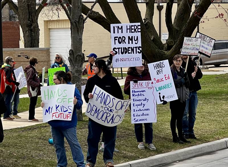 Protestors gather in front of the Grandon Civic Center and the post office on Saturday, April 5, in Sterling to voice concerns over President Donald Trump and his administration.