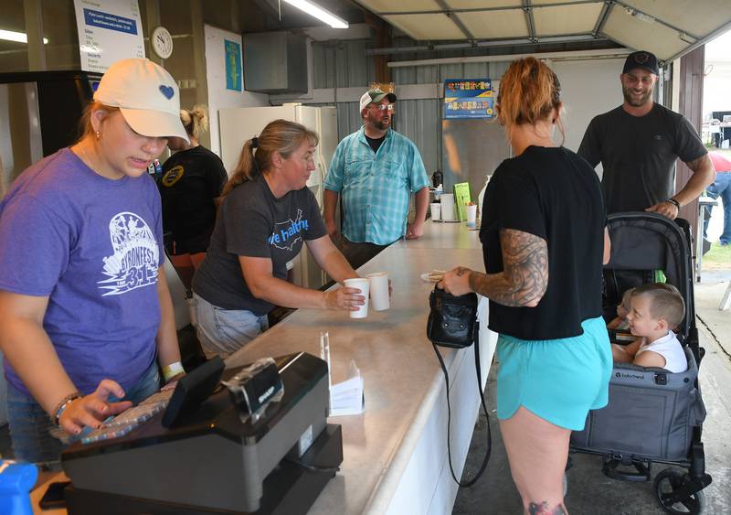 Alex Colbert and Cid Nevenhoven of Leaf River order hot dogs for themselves and Autum and Jeremy, at the Ag in the Classroom food stand at the Ogle County Fair on Saturday.