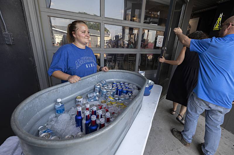 Addy Willey dishes out cold beer Wednesday, June 21, 2023 outside of Tipsy’s in downtown Dixon during the city market. While many opted for the air conditioning, the beer was a popular seller.