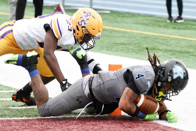 Kankakee's James Stampley, right, falls into the endzone for a touchdown during Saturday's 27-7 win over Bloomington in the second round of the IHSA Class 6A Playoffs in Kankakee. Stampley had a rushing touchdown and receiving touchdown apiece.