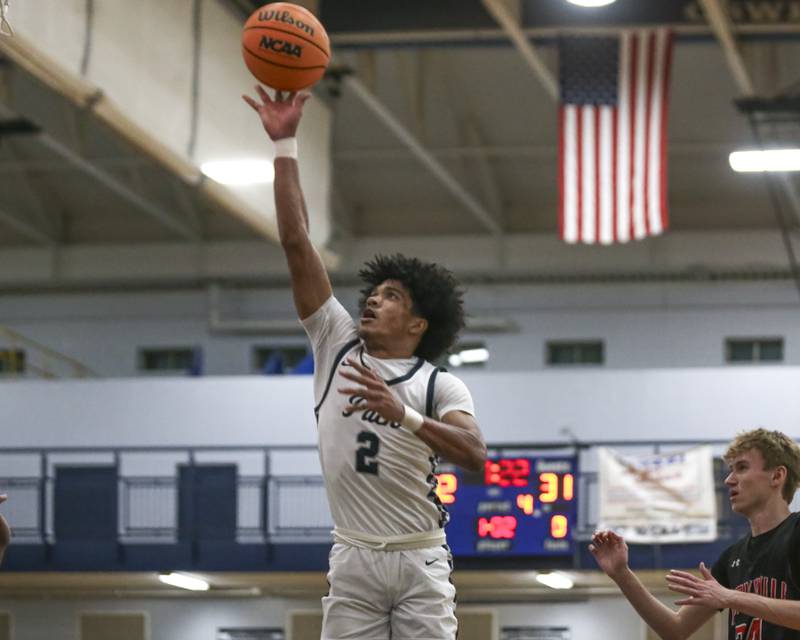 Oswego East's Jacsen Tucker (2) puts up a shot in front of the basket during their basketball game between Yorkville at Oswego East. Friday, Dec 19, 2025 in Oswego.