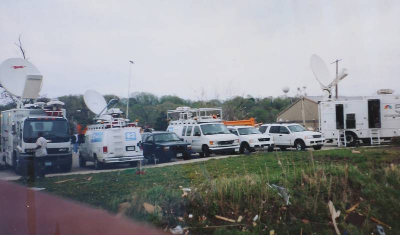 Chicago media vehicles park near the Illinois and Michigan Canal to cover the tornado damage on Wednesday, April 21, 2004 downtown Utica.