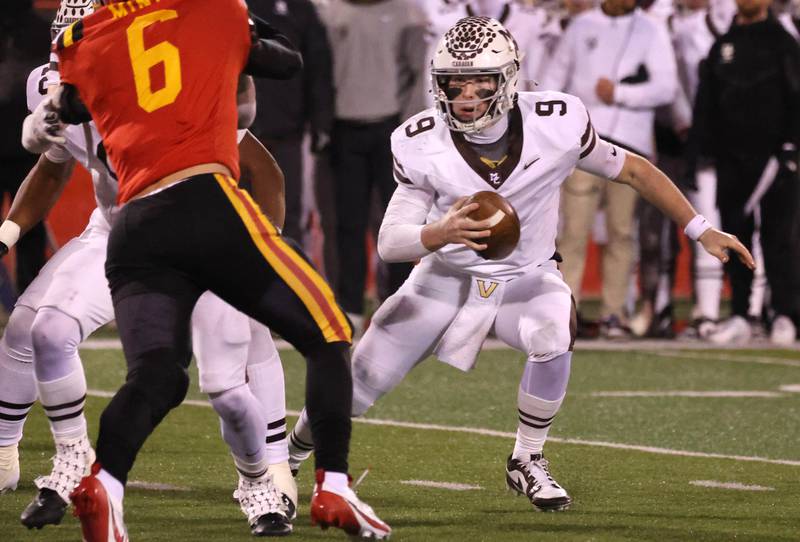 Mt. Carmel's Jack Elliott tries to avoid the pressure of Batavia's Tony Minnec during their Class 8A state championship game Saturday, Nov. 30, 2024, in Hancock Stadium at Illinois State University in Normal.
