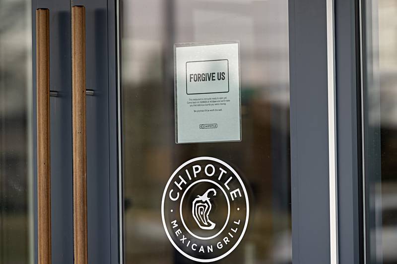 A sign on the door at the Dixon Chipotle announces the store will be opening Friday at 10:30 am.