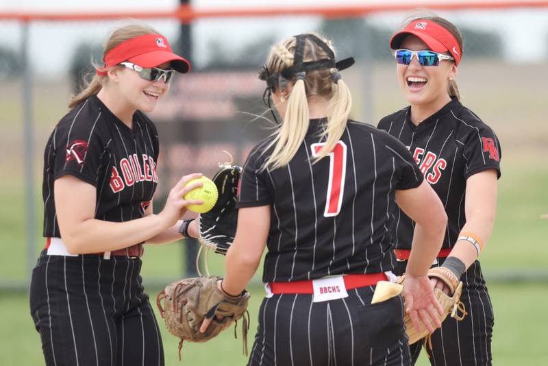 Bradley-Bourbonnais' Abbie Hofbauer, left, and Shannon Lee, right, congratulate Lydia Hammond after one of Hammond's 14 strikeouts in the Class 4A Normal Regional championship against Normal Community Friday, May 22, 2026.