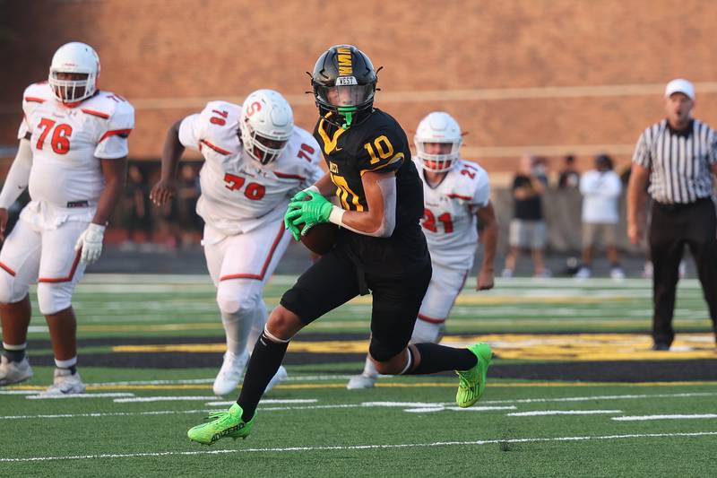 Joliet West’s Parker Schwarting turns upfield after a catch against Shepard on Friday, Aug. 25, 2023 in Joliet.