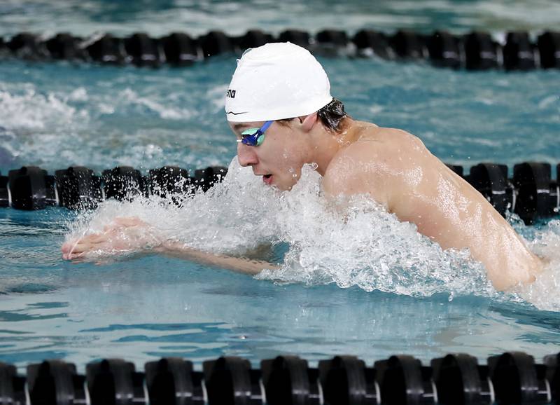 Cary-Grove’s Kasparas Venslauskas swims the breaststroke as he competes in the 200 medley relay during the  Fox Valley Conference Invitational swim meet on Saturday,  Feb. 15, 2025, at Woodstock North High School.