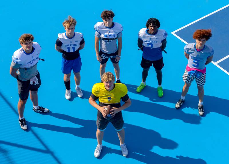 St. Francis QB Brady Palmer, center front, back row, from left, Gavin Mueller, Tanner Glock, Dario Milivojevic, Ian Willis, Zach Washington.  St. Francis receivers make a “Team Within a Team" Tuesday, Sept. 17, 2024 in Wheaton.