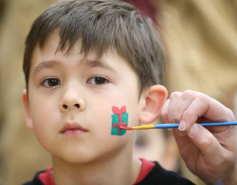 Max Milus of La Salle, has his face painted during the Santa's Workshop event on Saturday, Dec. 7, 2024 at La Salle-Peru Township High School.