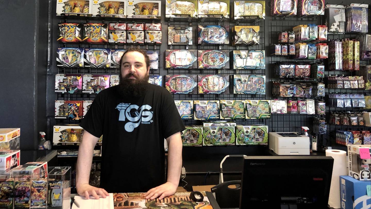 The Game Shop co-owner Nick Vidmar behind the register at the new location in downtown Oswego's Reserve at Hudson Crossing at Washington (Route 34) and Harrison streets.