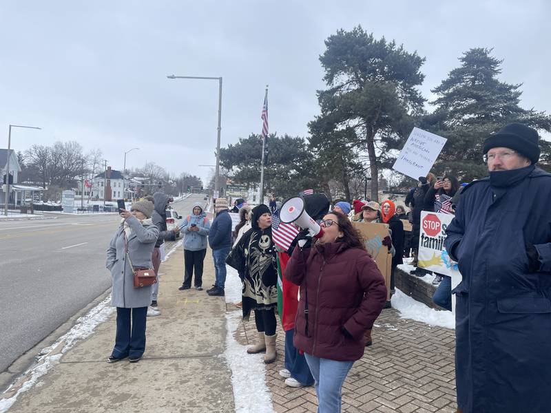Demonstrators gather in protest Sunday, Feb. 16, 2025, at Peace Corner in DeKalb.