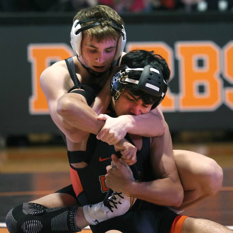 Sycamore’s Jayden Dohogne wraps up DeKalb’s Alan Izaguirre Friday, Jan. 17, 2025, during their 138 pound match at DeKalb High School.