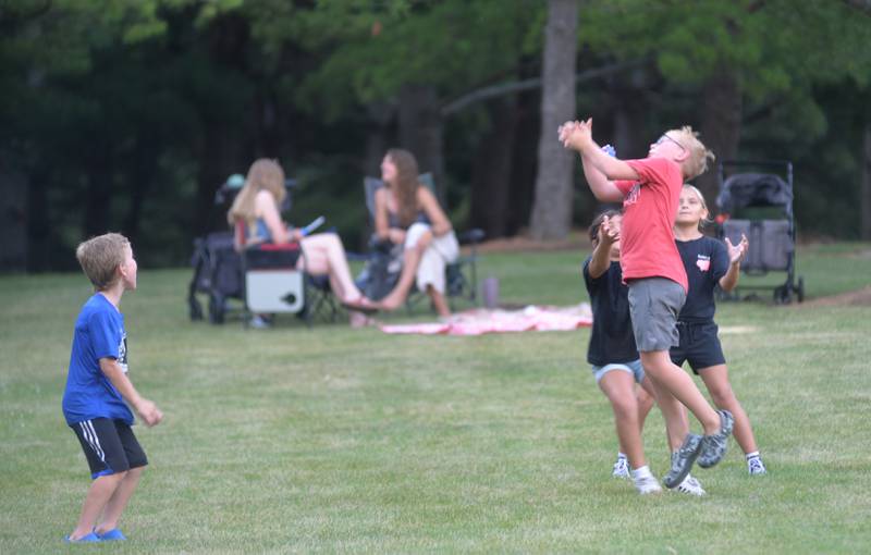 Kids play catch at Oregon Park West as “Buzzed by SonSET,” performs at the Oregon Park District’s Concert in the Park on Tuesday, June 24.