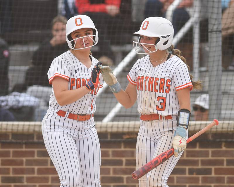 Oswego's Brynn Broughton, left, gets congratulated by teammate Sophie Morland (3) after scoring a run on Friday May 22, 2026, during the regional final game while taking on Benet Academy held at Oswego High School.