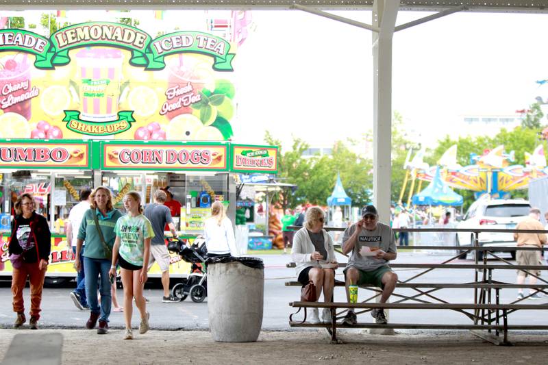 A couple stops for a break during the 156th Annual Kane County Fair on Thursday, July 17, 2025 in St. Charles. The fair runs through Sunday, July 20, 2025.