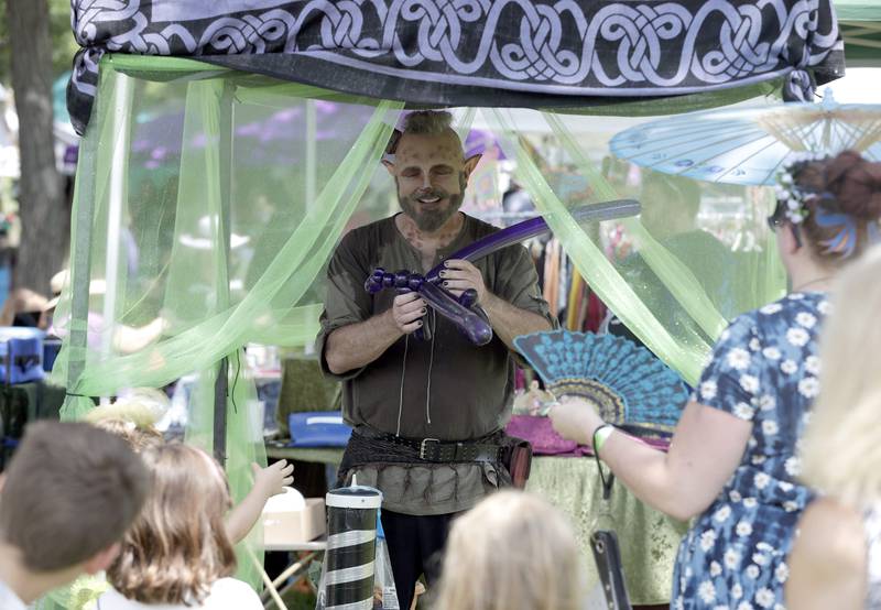 A little hot air couldn't keep Michael Ohair aka the Twister from making balloon animals during the World of Faeries Festival Saturday August 6, 2022 at Vasa Park in South Elgin.