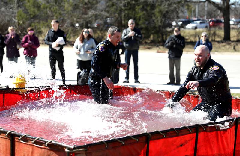 Wheaton Police officers Chris Dempsey (left) and Seth Berlin take the plunge during the Wheaton Police Department’s annual polar plunge to benefit Illinois Special Olympics on Saturday, March 22, 2025 at the Wheaton Fire Department.