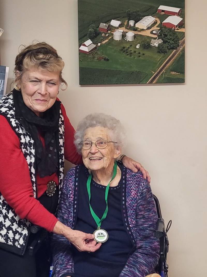 Eleanor Zimmerlein of LaMoille (seated) received the Erickson McCrum Agricultural Mentor Award for her years of mentoring other women in the organization. The award was announced at the annual national meeting in Sacramento, Calif. and was presented personally to Zimmerlein in her home by Pat Yaegle (standing), another long-time Illinois member, friend and Agriwomen officer. American Agriwomen is the nation's largest coalition of farm, ranch and agribusiness women, with more than 50 state, commodity and agribusiness affiliates. The organization promotes, protects and educates on American agriculture.