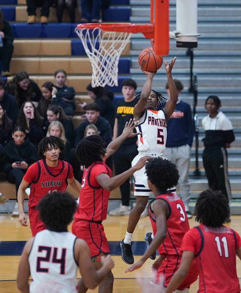 Oswego’s Tyrell Mays (5) shoots the ball on the baseline against West Aurora during a basketball game at Oswego High School on Friday, Dec 1, 2023.