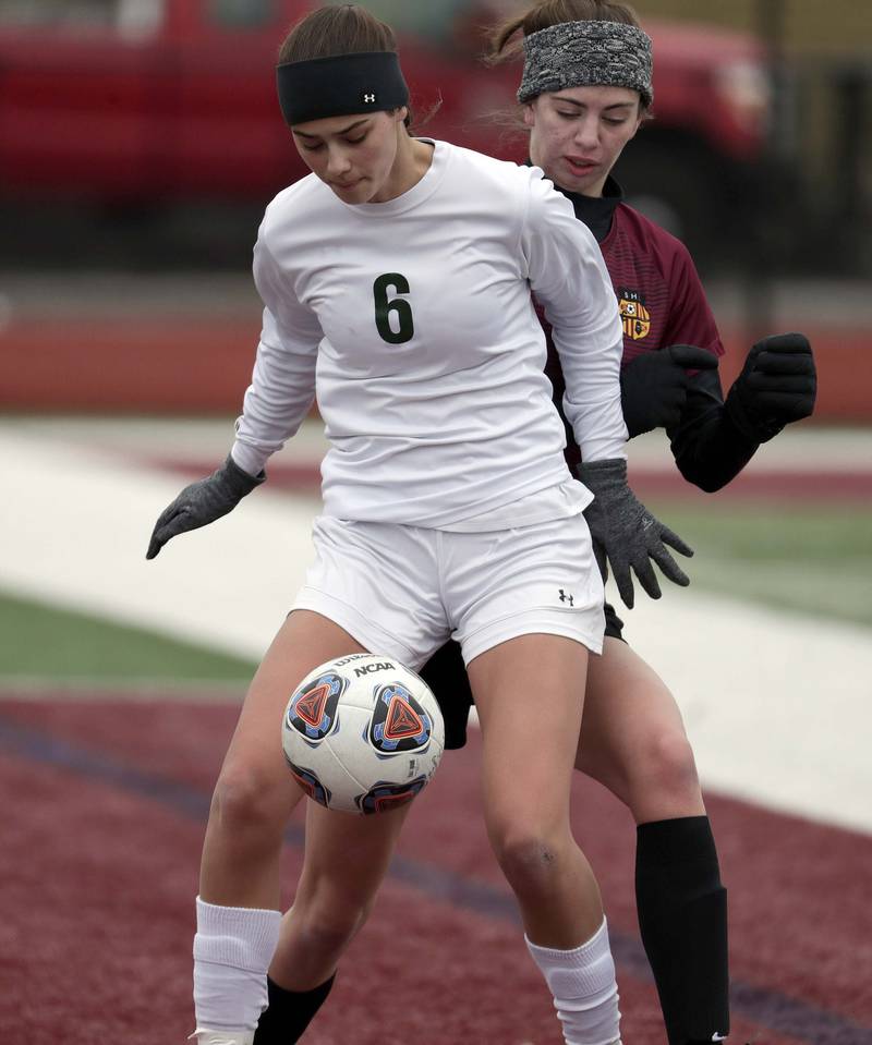 Crystal Lake South's Carly Gorman keeps Schaumburg's Emma Jevtic on her back during girls soccer action Saturday, March 26, 2022 in Schaumburg.