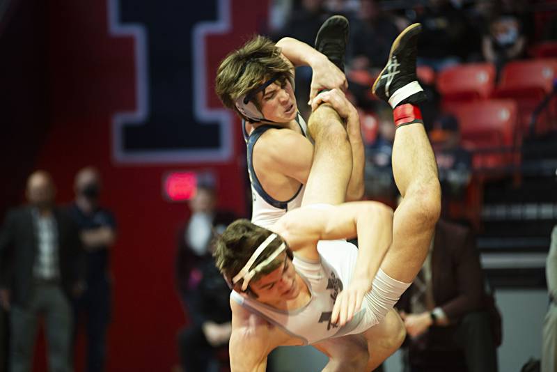 IC Catholic's Michael Calcagno hoists Unity's Grant Albaugh during the 1A 182lb finals match at the IHSA state wrestling meet on Saturday, Feb. 19, 2022.