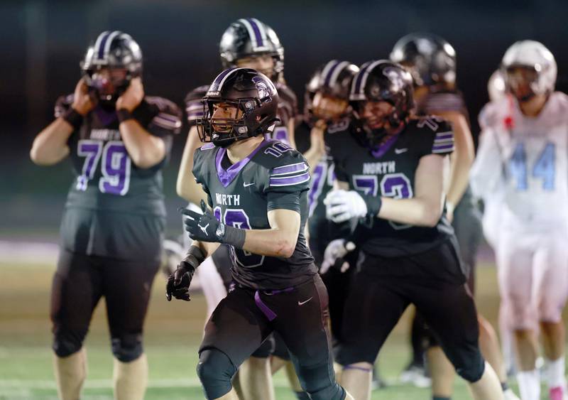 Downers Grove North's Oliver Thulin (10) celebrates their win after the IHSA Class 7A playoff football game Friday, Oct. 31, 2025 in Downers Grove.
