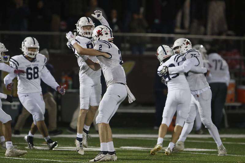 St. Viator players celebrate their 14-0 win over Richmond-Burton in a IHSA Class 4A first round playoff football game Friday, Oct. 27, 2023, at Richmond-Burton High School in Richmond.