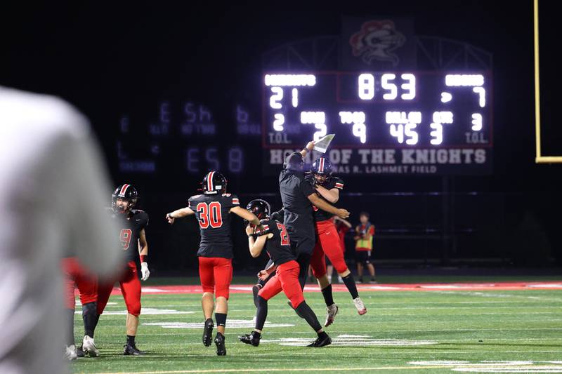 Lincoln-Way Central's Aiden Hennings celebrates an interception with a coach during the Knight's 28-20 victory over Bradley-Bourbonnais on Friday, Oct. 3, 2025.