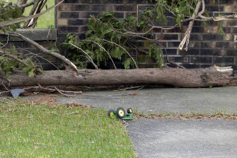 A children’s toy is seen among downed trees and other damage Friday, April 3, 2026. Thursday evening storms caused a swath of damage across the area.