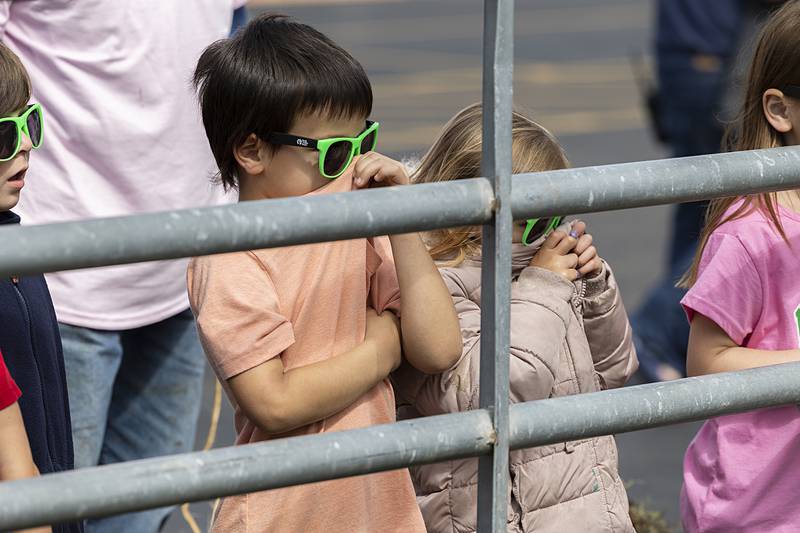 Jefferson School kindergarteners hold their noses as a cow they were visiting does her business Thursday, May 9, 2024 at Sterling High School’s FFA Farmapalooza. Several groups brought in farm animals for the students to learn about.