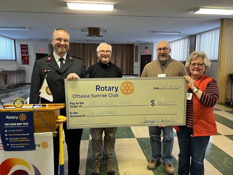 (Left to right) Salvation Army Lt. Wayne Strayer receives a $600 donations from Sunrise President Gene Anderson, Treasurer Joe Schmidt and Collection Chair Sandy Robinson.