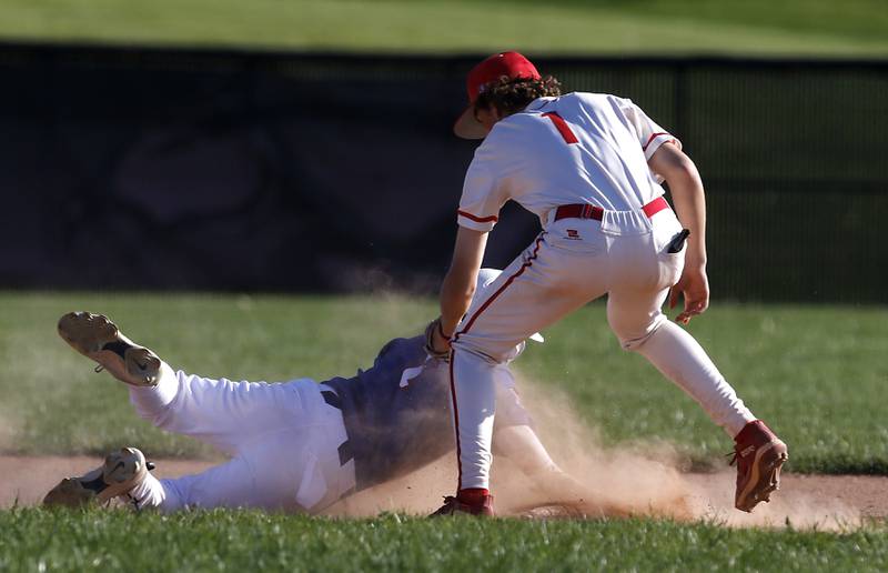 Huntley's Tyler Jakubowski tags out Dundee-Crown's Brady Benton as he dives back to second base during a Fox Valley Conference baseball game on Friday, May 9, 2025, at Huntley High School.