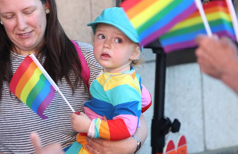 Owen Davies, 2, from DeKalb, and his mom Jennifer Johnson, check out all the colorful flags as they wait for the parade to start Thursday, June 23, 2022, during an event to celebrate Pride month in DeKalb. The function included a short parade through downtown and a showing of the movie “Tangerine,” with a panel discussion afterwards at the Egyptian Theatre.