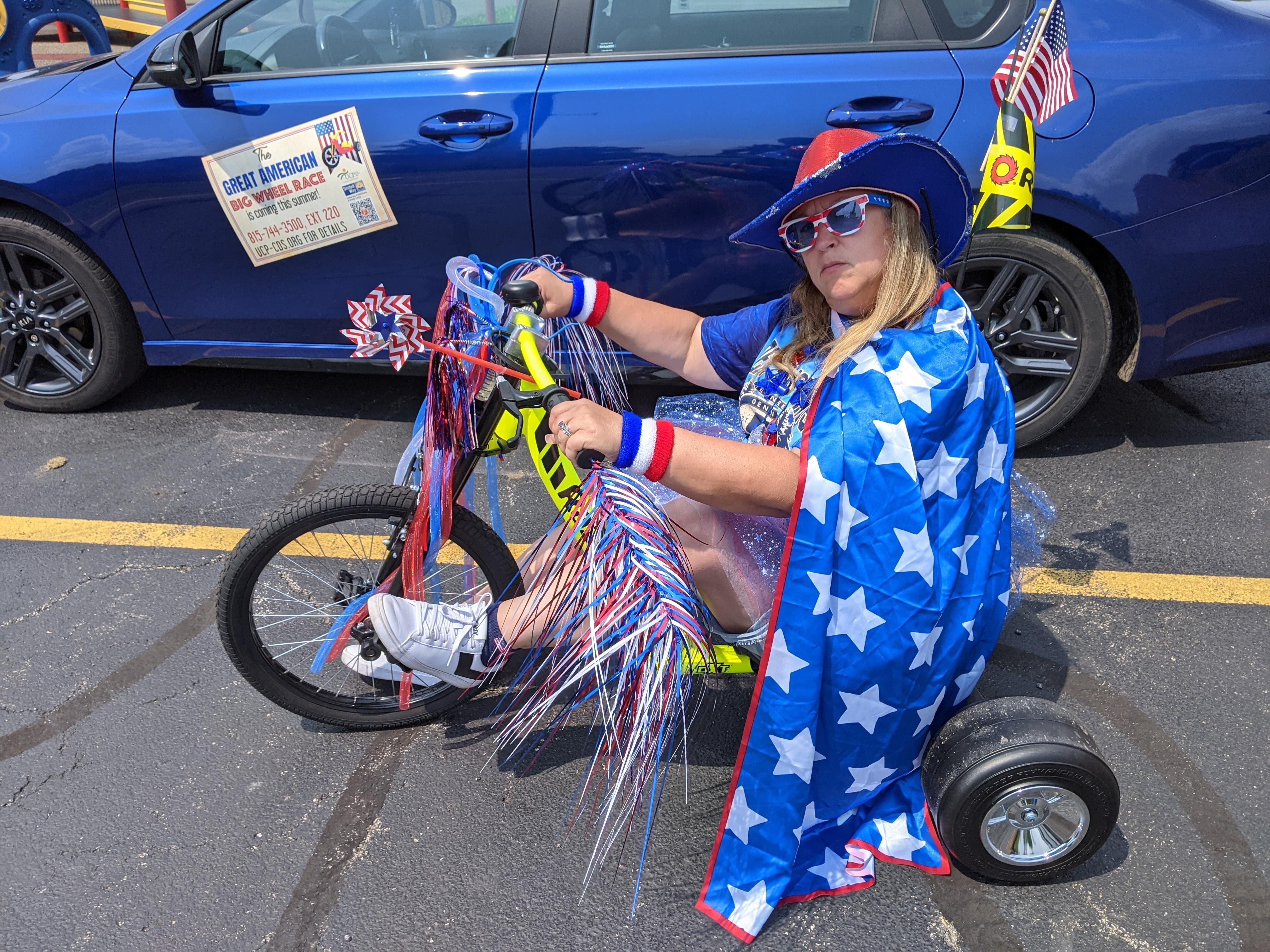 Gina Wysocki, development director and co-chair of the fundraising committee at The United Cerebral Palsy-Center for Disability Services, poses in 2021 on one of the adult Big Wheels that was ridden in nonprofit's first "The Great American Big Wheel Race."