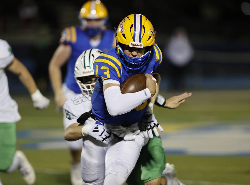 Lyons' Jack Slightom (13) runs the ball during the varsity football first-round 8A playoff game between York and Lyons Township on Friday, Oct. 31, 2025 in Western Springs, IL.