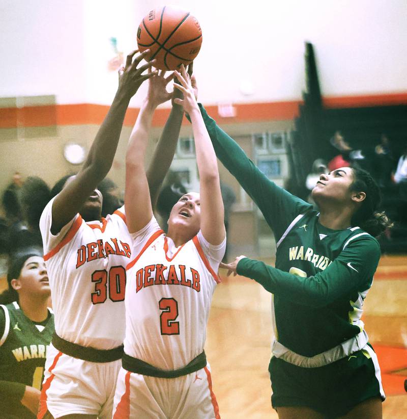 DeKalb's Tizaria Sykes and Ella Medina try to grab a rebound away from Waubonsie Valley's Aalyiah Aranda during their game Thursday, Dec. 15, 2022, at DeKalb High School.