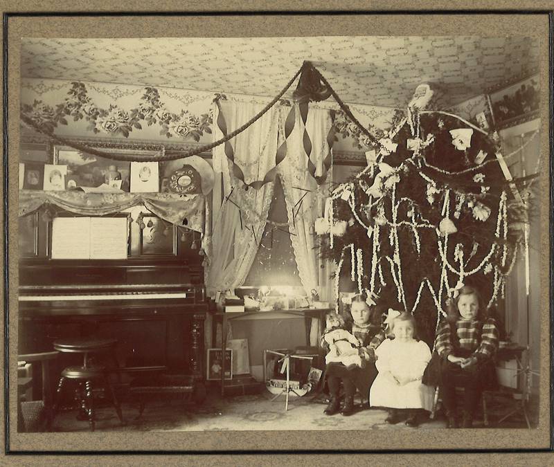 An undated photo of Axtell family children in front of their Christmas tree. Alonzo Axtell was a prominent businessman in Harvard who opened a bank there in 1877 and was a founder of the McHenry County Republican Party.