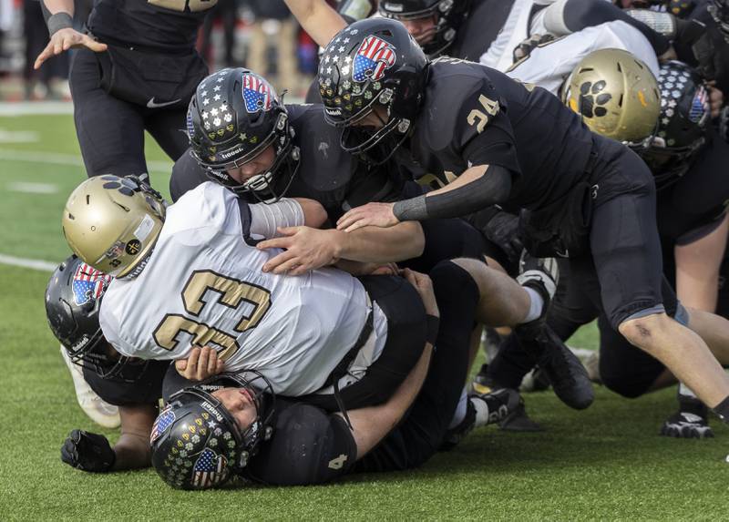 The Lena-Winslow defense stops Camp Point's Elijah Genenbacher Friday, Nov. 24, 2023 in the 1A state football championship game at Hancock Stadium in Normal.