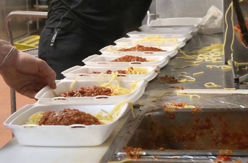 Containers of spaghetti are prepared during the 24th annual Lighted Way Spaghetti dinner on Monday, March 27, 2023 at Uptown in La Salle.
