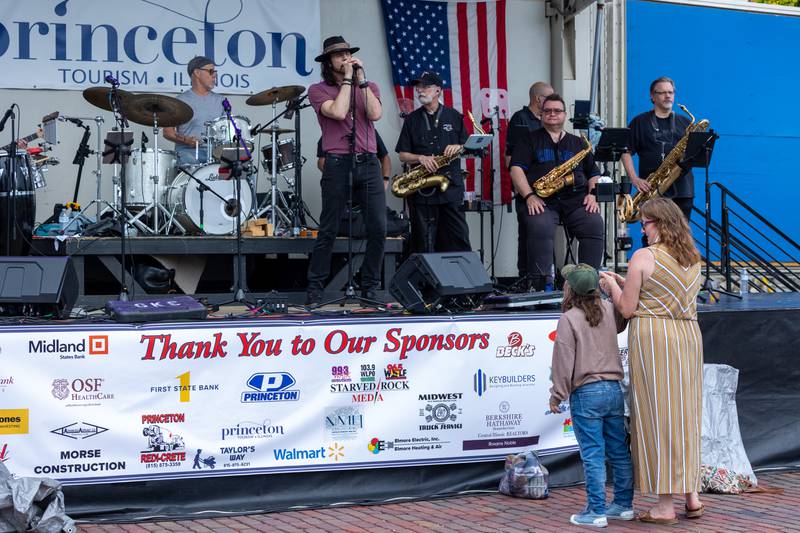 Tricia Pinter and Kyla Kissick watch  “Brass From The Past” performance at the annual Shrimp Fest on Saturday, June 7, 2025 at Rotary Park in Princeton.